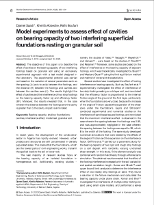 Model experiments to assess effect of cavities on bearing capacity of two interfering superficial foundations resting on granular soil